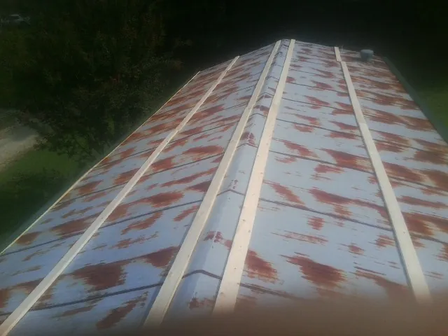 Rusted metal roof panels with new wood purlins before replacement — Storm Damage Roof Repair in Bridgeville by Roofing Brothers