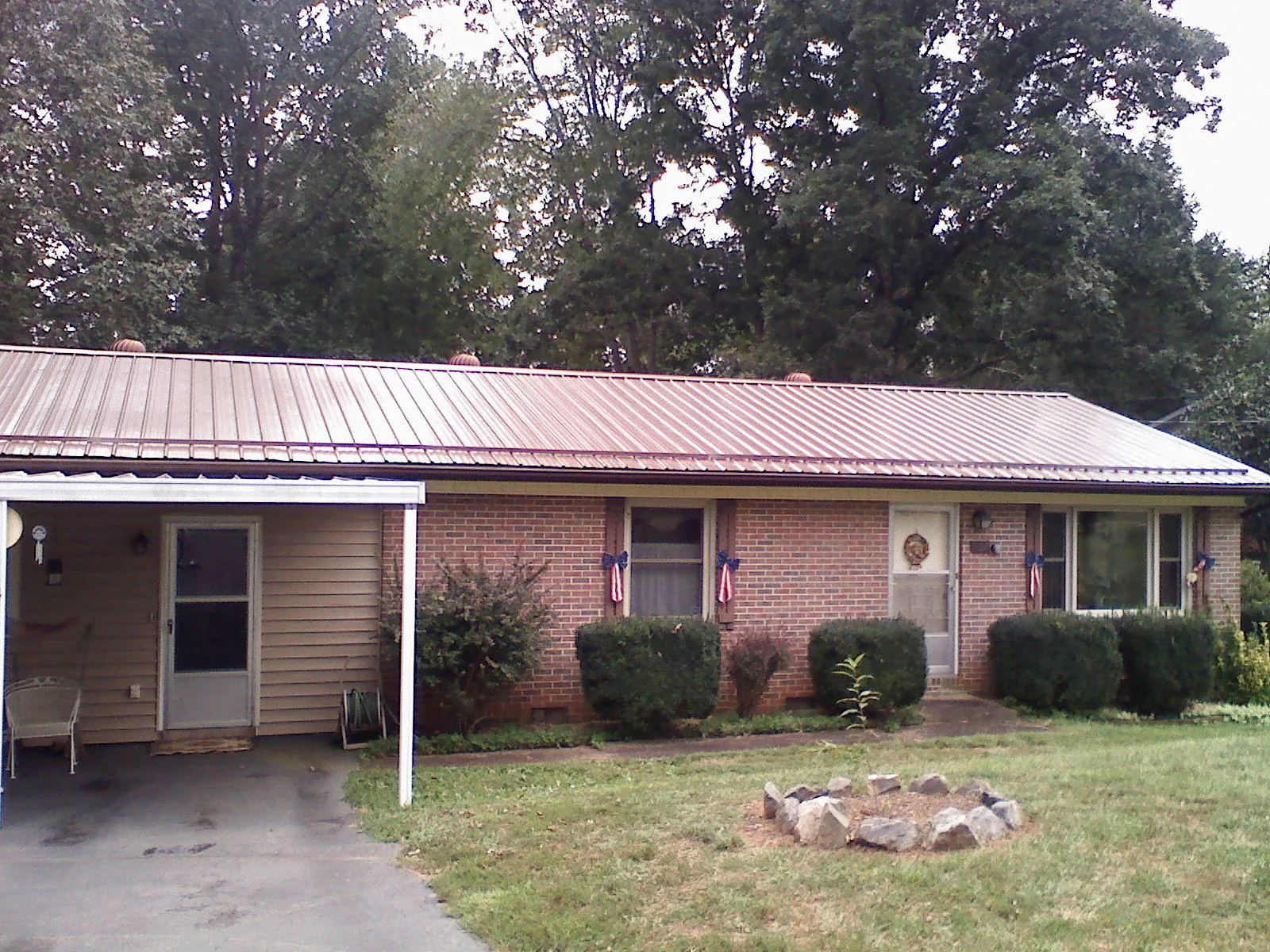 Bronze metal roof and carport on a brick ranch home — Roof Repair work by our crew in Bridgeville